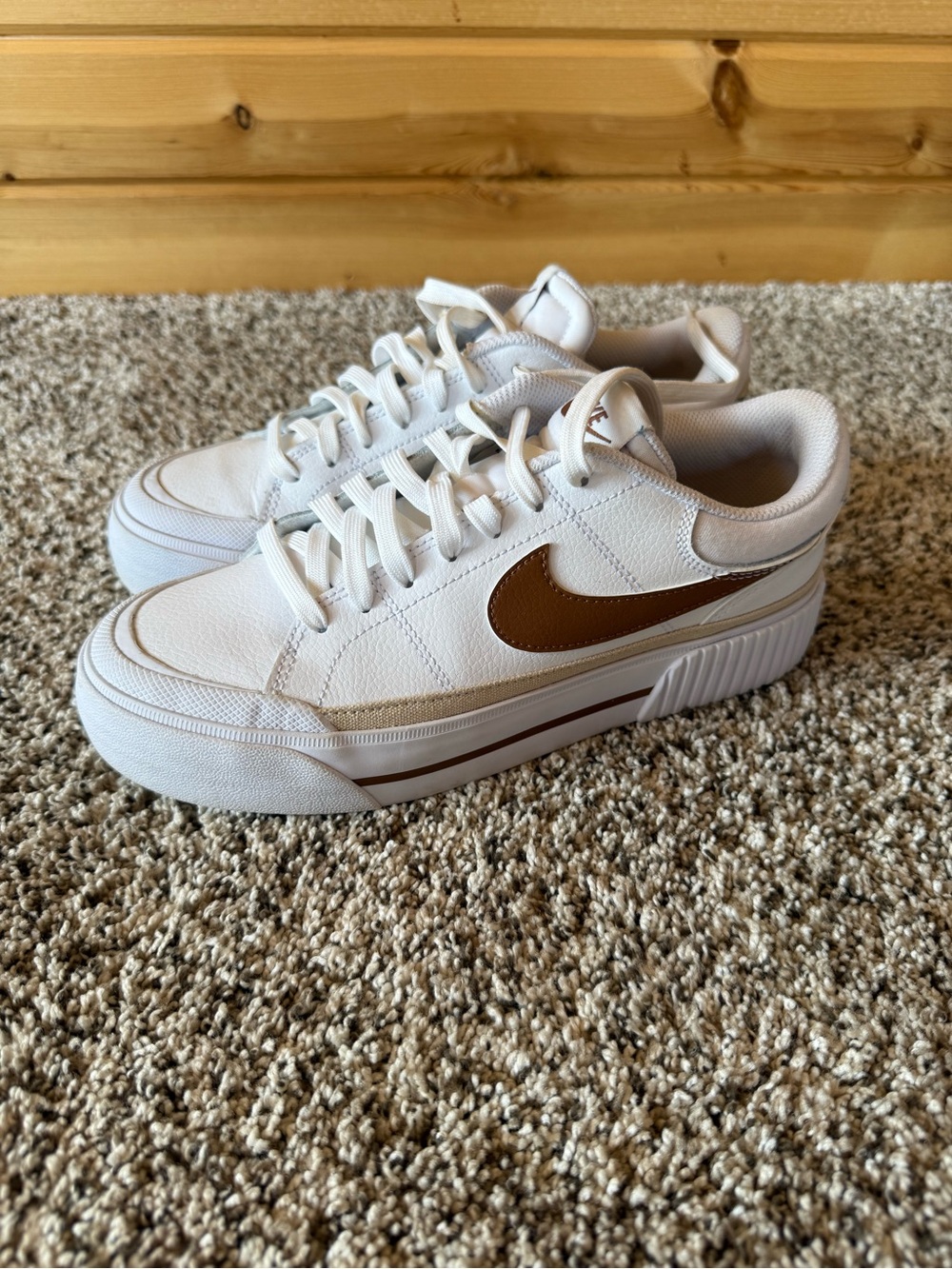 Nike White Low-Top Sneakers with Brown Swoosh Accent